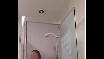 Big-breasted girlfriend pleases herself in the shower